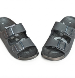 Front view of a pair of beige double-buckle slide sandals with open toes and contoured footbeds on a white background.